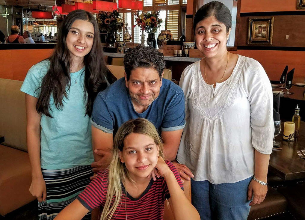 Sam and Viji with their two daughters, Anika and Maya.